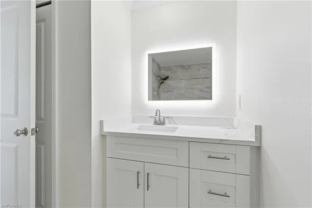 a bathroom with a sink and a mirror