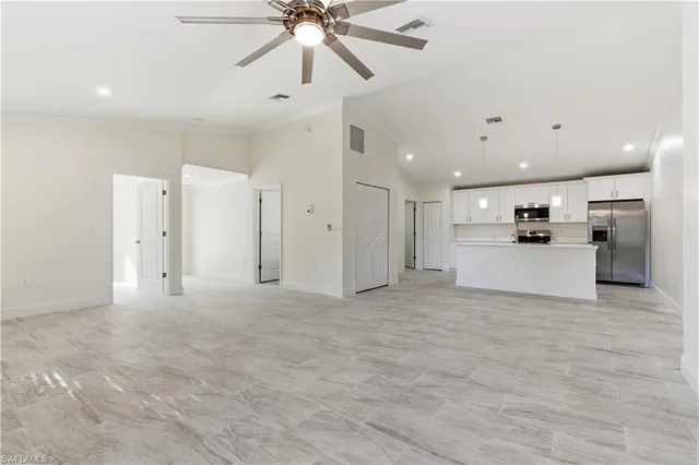 a view of a kitchen with a sink and a refrigerator