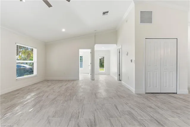 a view of a livingroom with wooden floor and window