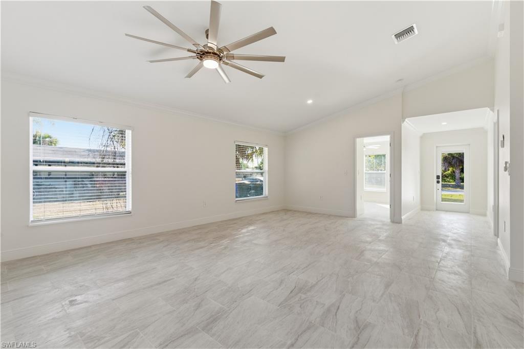 2141 Davis Street Fort Myers, FL 33916 - Photo 10 of 50 an empty room with chandelier fan and windows