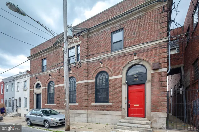 a kitchen with a refrigerator and white cabinets