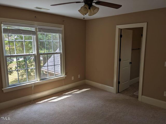 an empty room with a empty space and windows