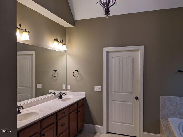 a bathroom with a double vanity sink and mirror