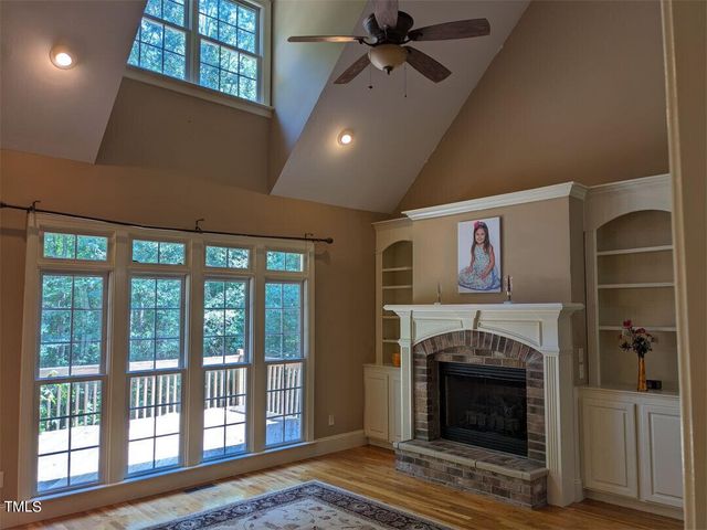 a view of a livingroom with a fireplace and window