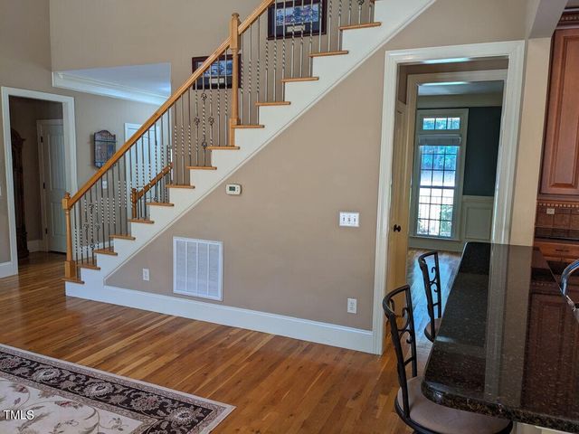 a view of entryway with a window and wooden floor