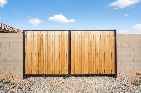 a view of an empty room with a kitchen and a stove top oven