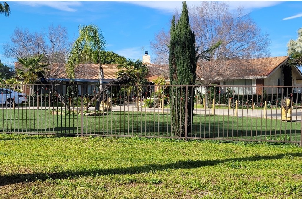 a front view of a house with a garden and plants