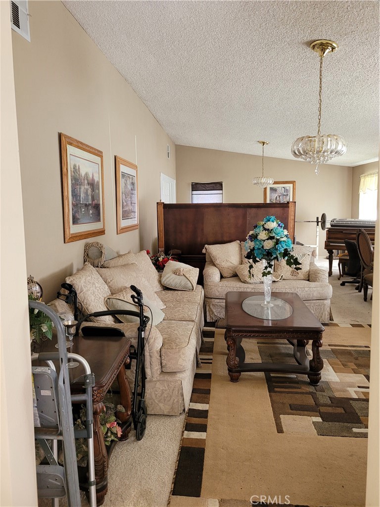 8805 Dufferin Avenue Riverside, CA 92504 - Photo 21 of 23 a living room with furniture and a chandelier