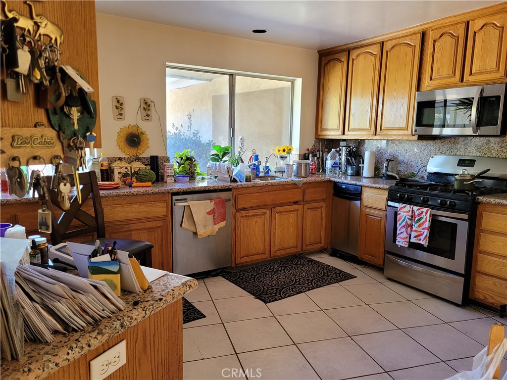 8805 Dufferin Avenue Riverside, CA 92504 - Photo 23 of 23 a kitchen with stainless steel appliances a stove a sink and a microwave