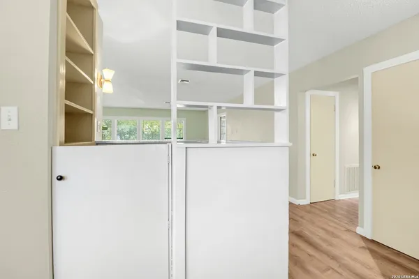 a view of a bedroom with wooden floor and windows