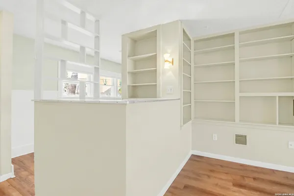 a view of a room with a wooden floor and a window