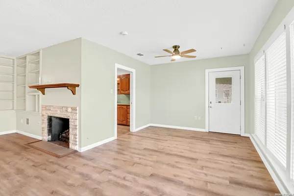 a view of an empty room with a fireplace