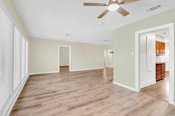 wooden floor in an empty room with a window