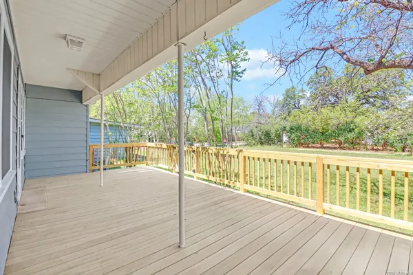 a view of a room with wooden floor and fence