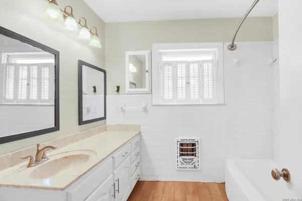 a bathroom with a sink a vanity and a mirror