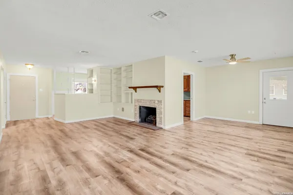 a view of empty room with a fireplace