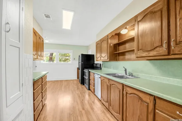 a kitchen with a sink and wooden cabinets
