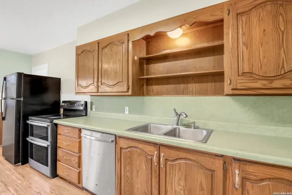 a kitchen with stainless steel appliances a sink and cabinets