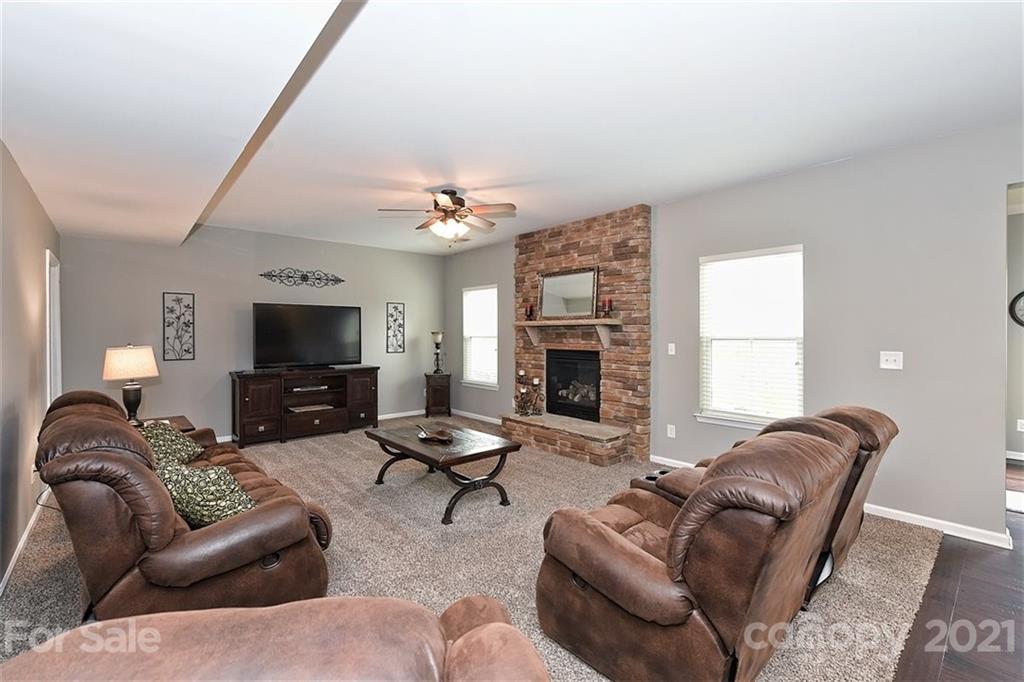 3006 Fallondale Road Waxhaw, NC 28173 - Photo 15 of 48 a living room with furniture a fireplace and a flat screen tv