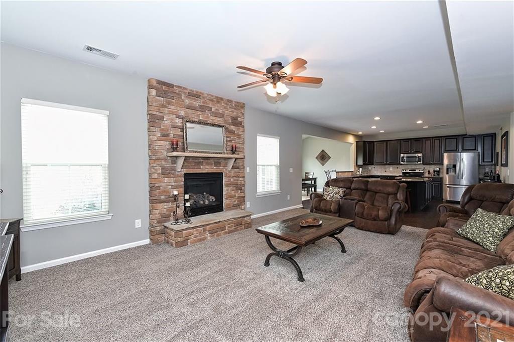 3006 Fallondale Road Waxhaw, NC 28173 - Photo 17 of 48 a living room with furniture a fireplace and window
