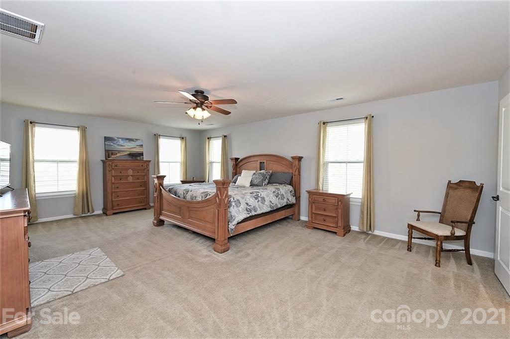 3006 Fallondale Road Waxhaw, NC 28173 - Photo 32 of 48 a spacious bedroom with a bed and a window