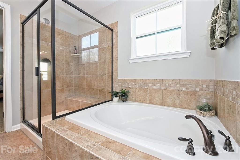 3006 Fallondale Road Waxhaw, NC 28173 - Photo 37 of 48 a bathroom with a tub and shower