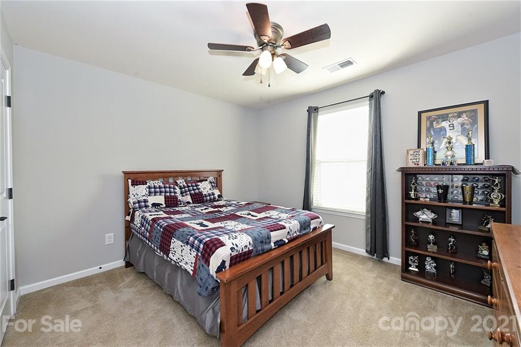 3006 Fallondale Road Waxhaw, NC 28173 - Photo 39 of 48 a bed sitting in a bedroom next to a window