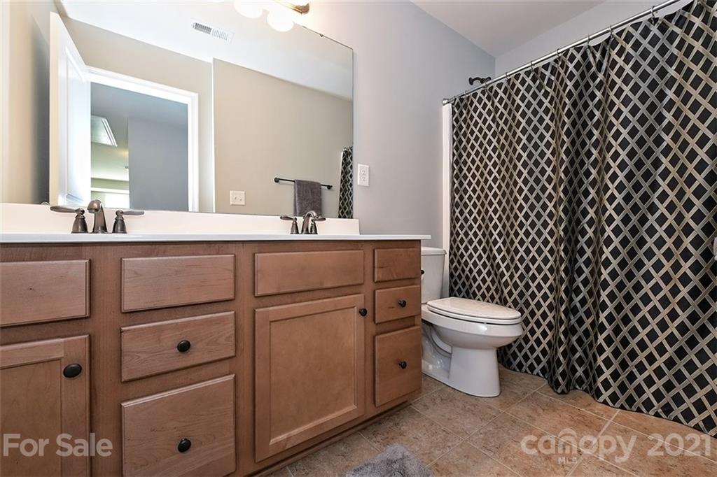 3006 Fallondale Road Waxhaw, NC 28173 - Photo 40 of 48 a bathroom with a toilet a sink and a mirror