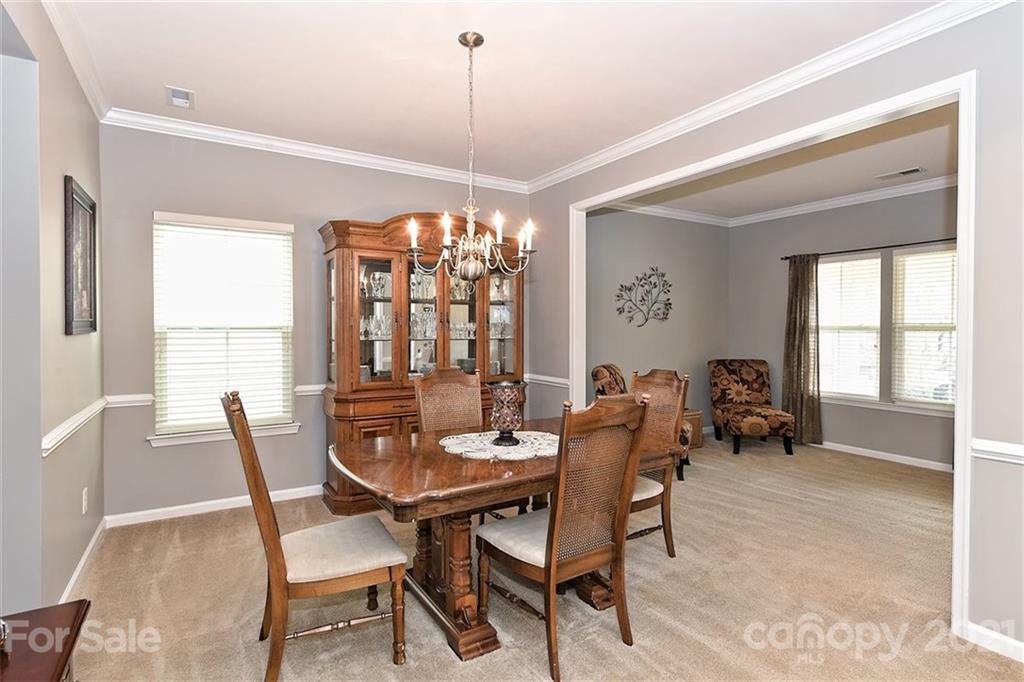 3006 Fallondale Road Waxhaw, NC 28173 - Photo 10 of 48 a dining room with furniture a chandelier and wooden floor