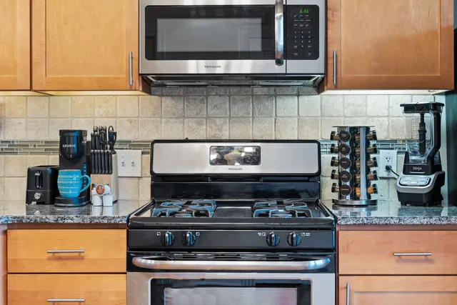 a stove top oven sitting inside of a kitchen