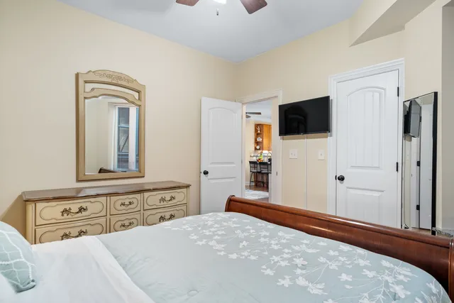 a bedroom with a bed and a flat screen tv