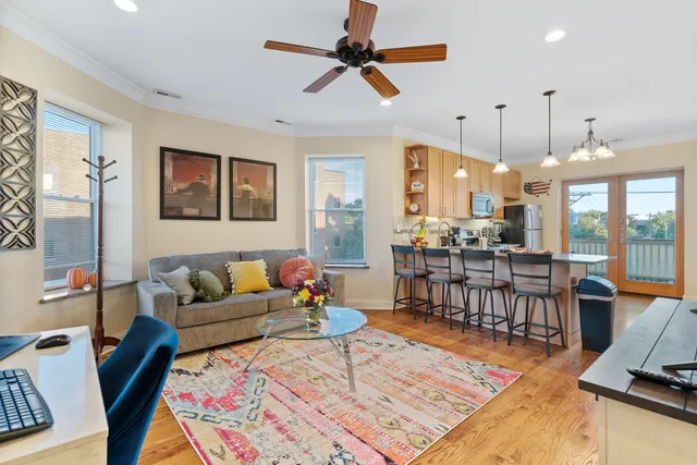 a living room with furniture a rug and a chandelier