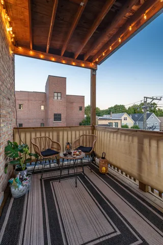 a view of a balcony with wooden floor and outdoor space