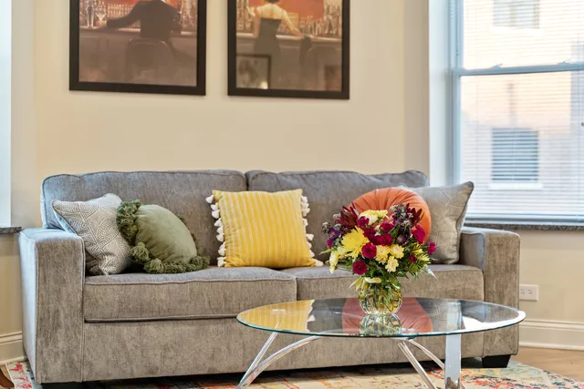 a living room with furniture and flowers