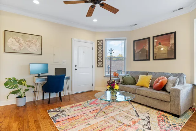 a living room with furniture and a potted plant