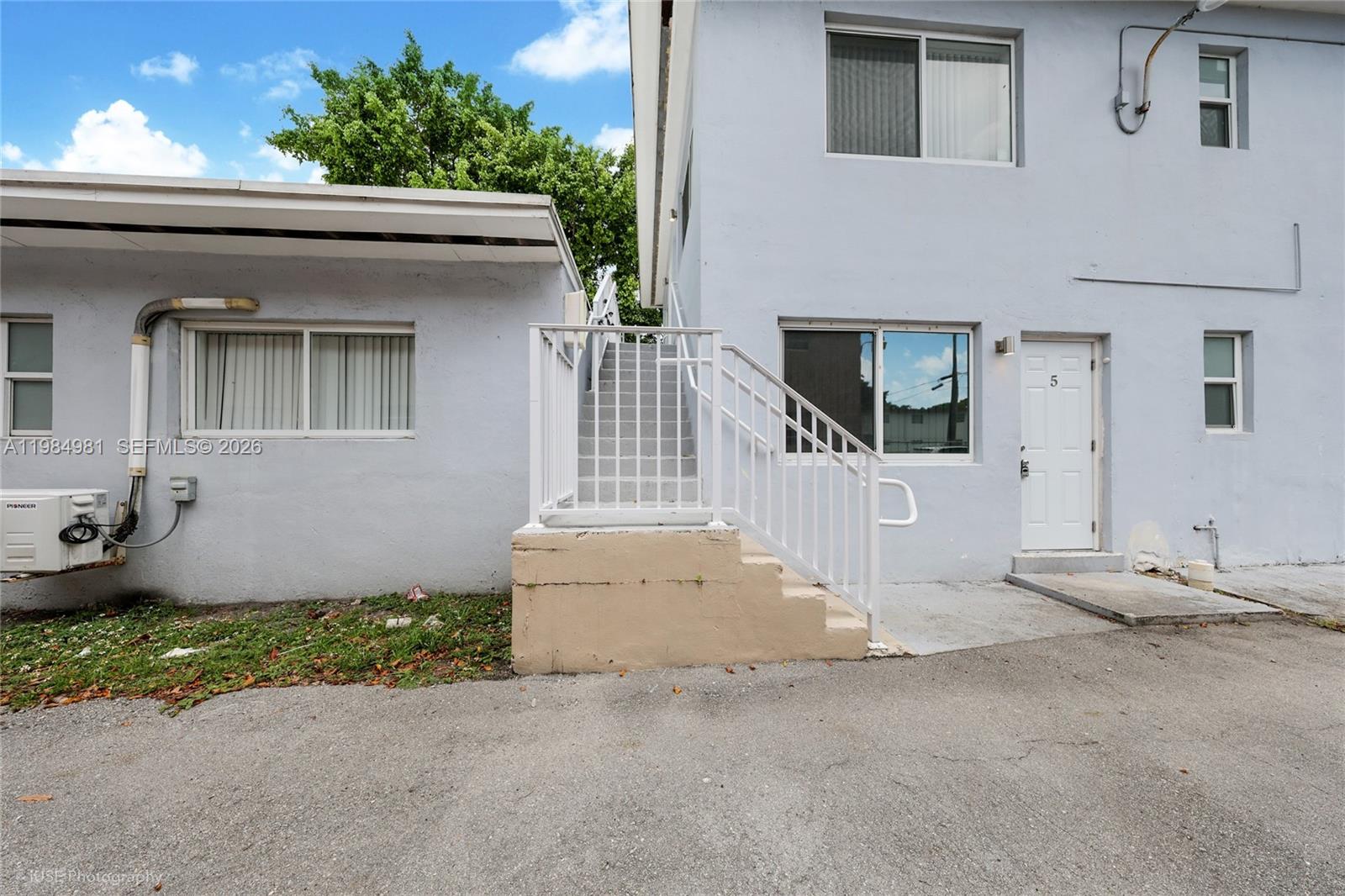 1145 Northwest 3rd Street, Unit 3 Miami, FL 33128 - Photo 1 of 8 a front view of a house with garden