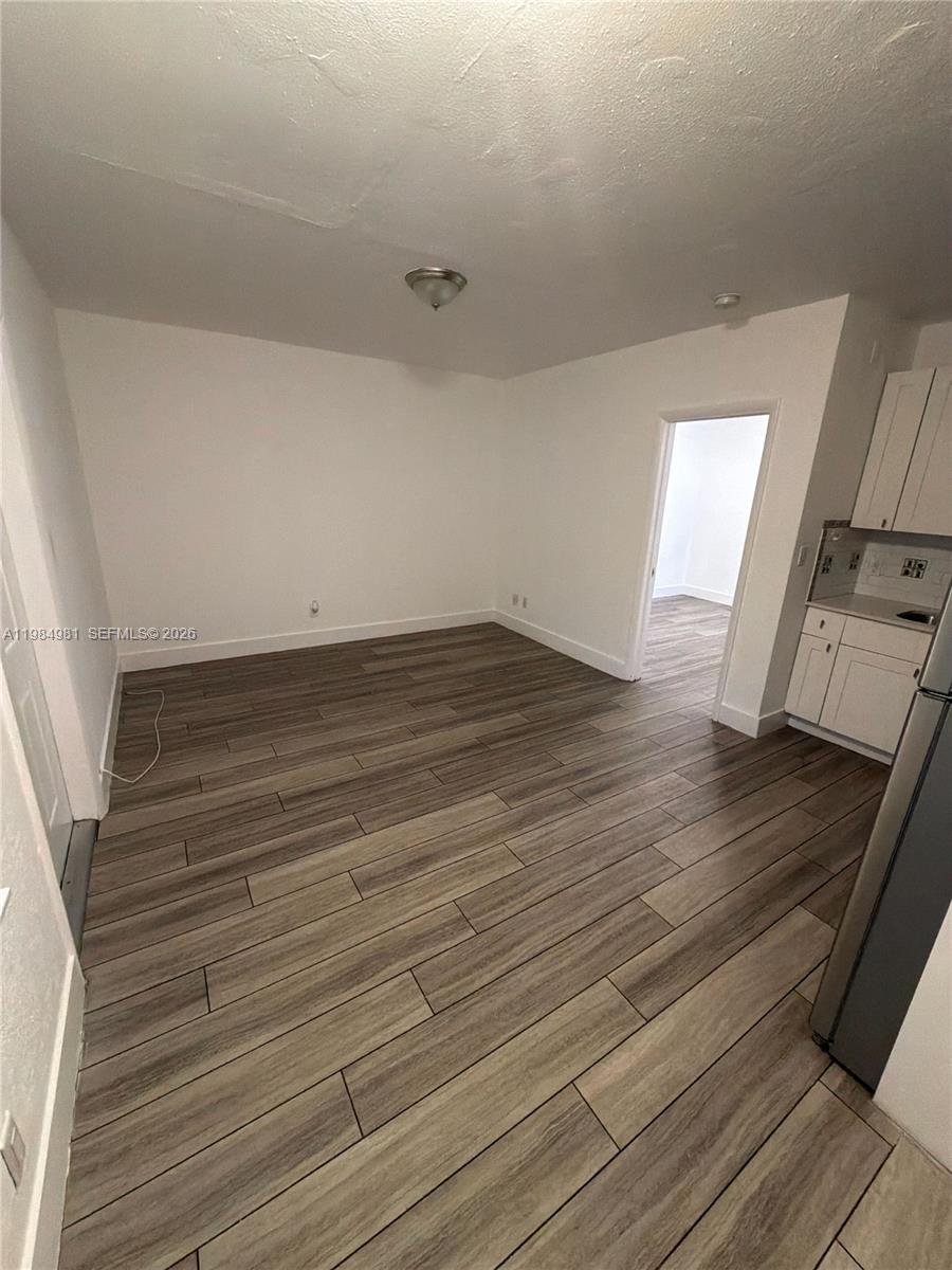 1145 Northwest 3rd Street, Unit 3 Miami, FL 33128 - Photo 4 of 8 a view of an empty room and wooden floor