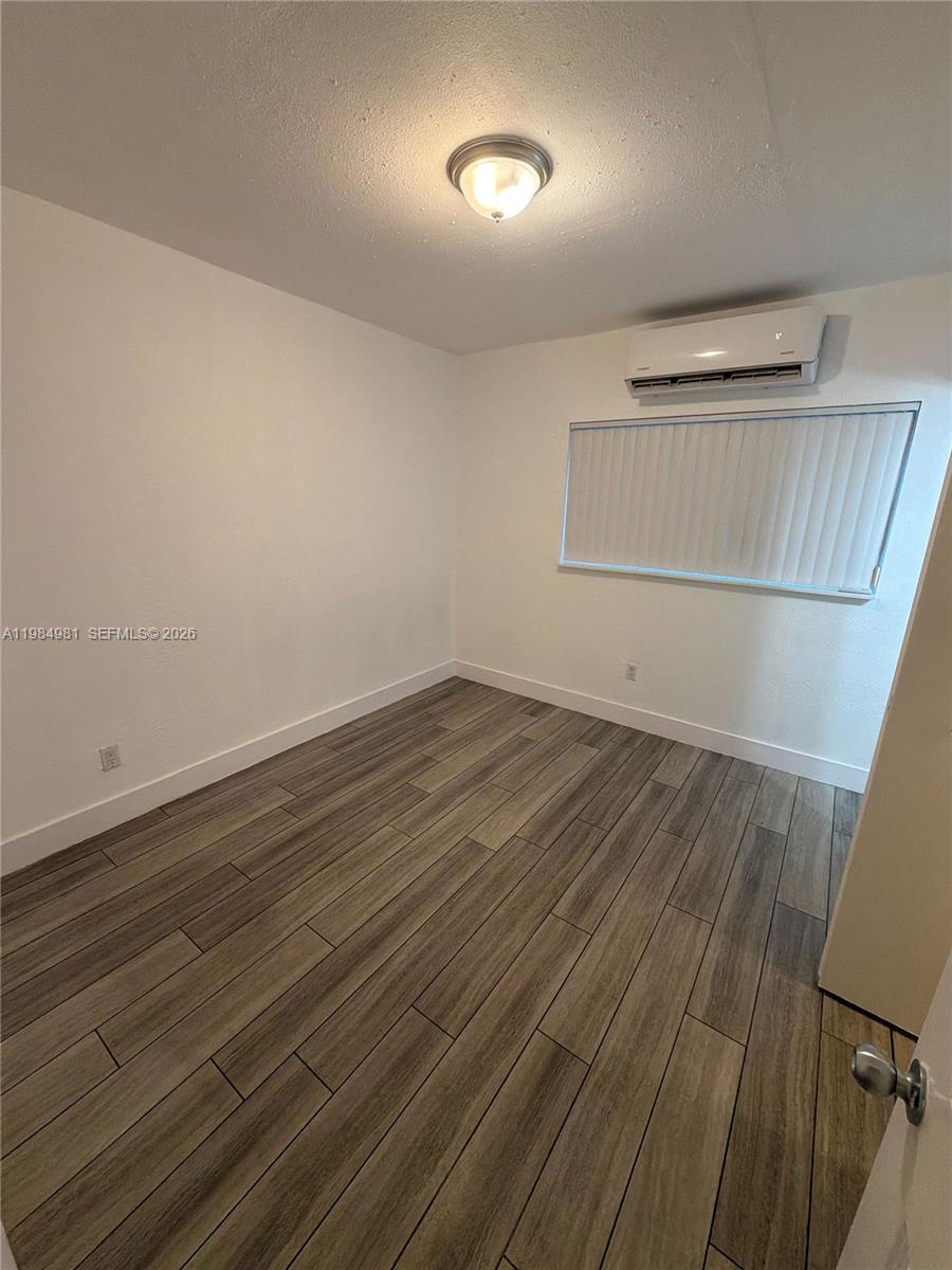 1145 Northwest 3rd Street, Unit 3 Miami, FL 33128 - Photo 7 of 8 a view of room with wooden floor