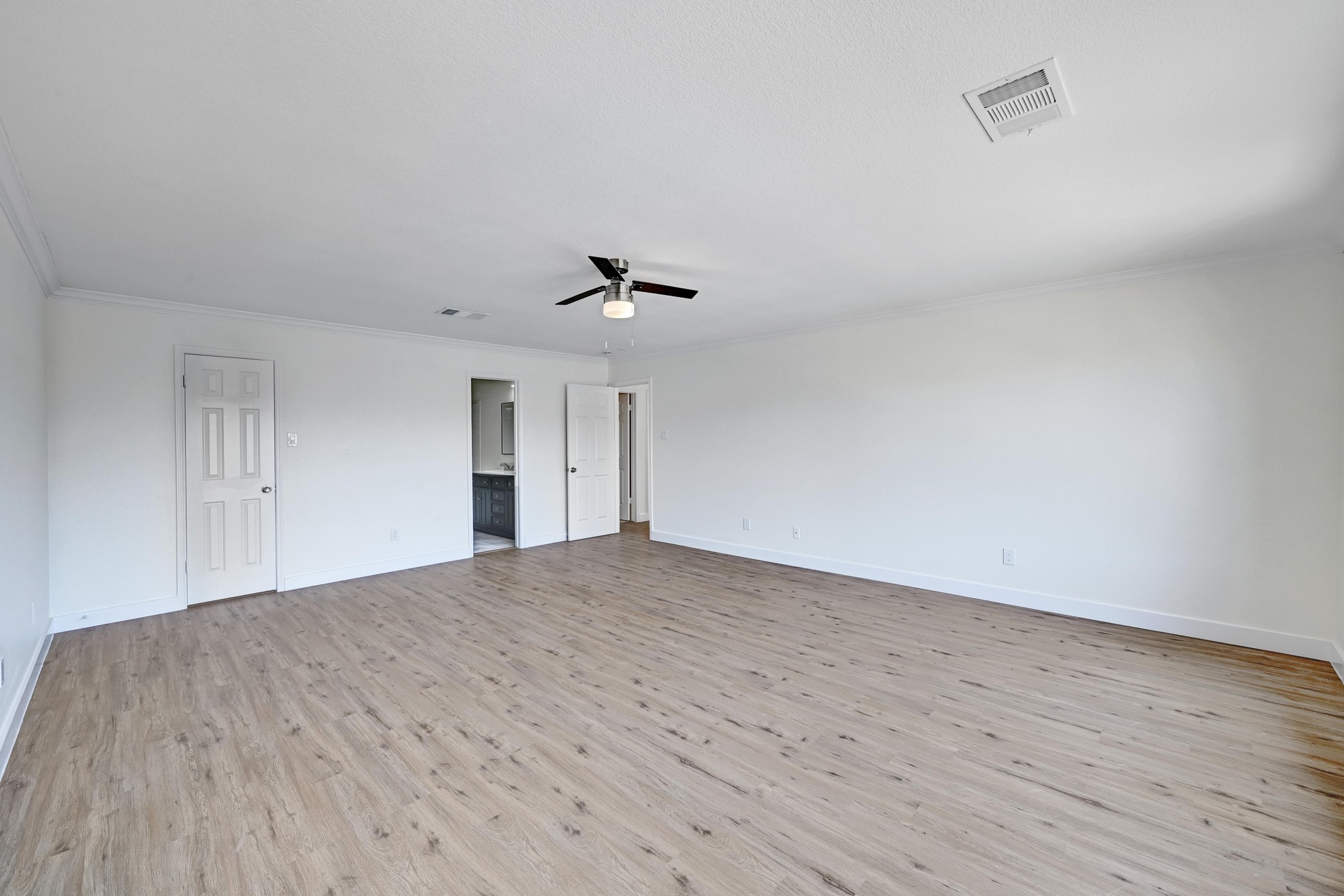 7413 L Marble Ridge Drive Austin, TX 78747 - Photo 14 of 30 Spacious room featuring wood-finish flooring, crisp white walls, and a contemporary ceiling fan