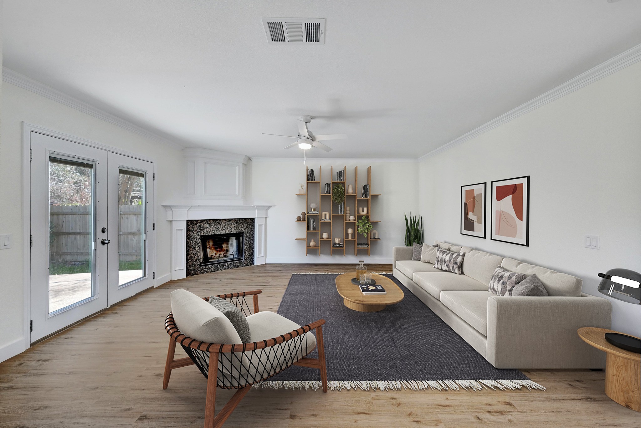 7413 L Marble Ridge Drive Austin, TX 78747 - Photo 5 of 30 Spacious living area featuring wood-finish flooring, a corner fireplace with a stone surround and white mantel, and double French doors opening to an outdoor space