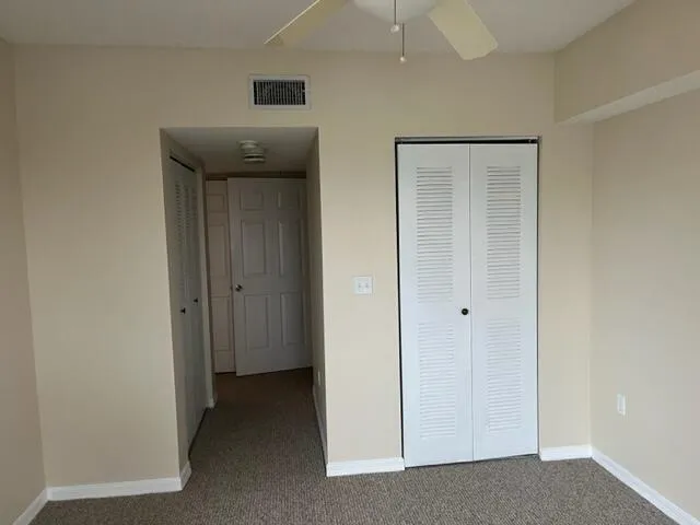 a white toilet sitting next to a shower