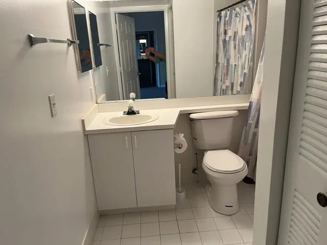 a front view of a house with a yard and palm trees