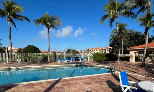 a view of swimming pool with a table and chairs