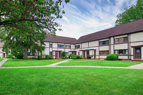 a front view of a building and a garden