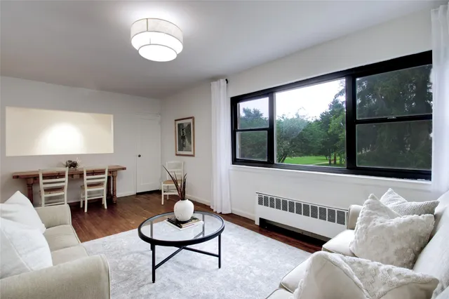 a living room with furniture and a large window