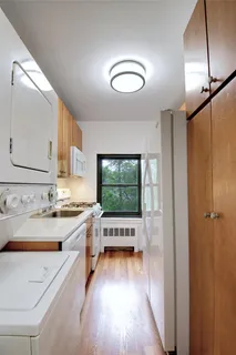 a view of a kitchen with a sink and a large window