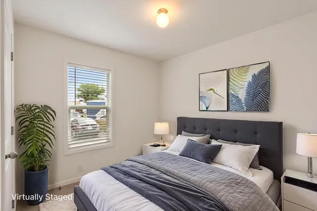 a bedroom with a bed and a window