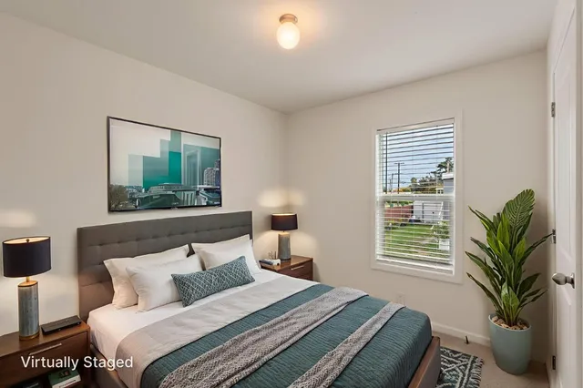 a bedroom with a large bed and a window