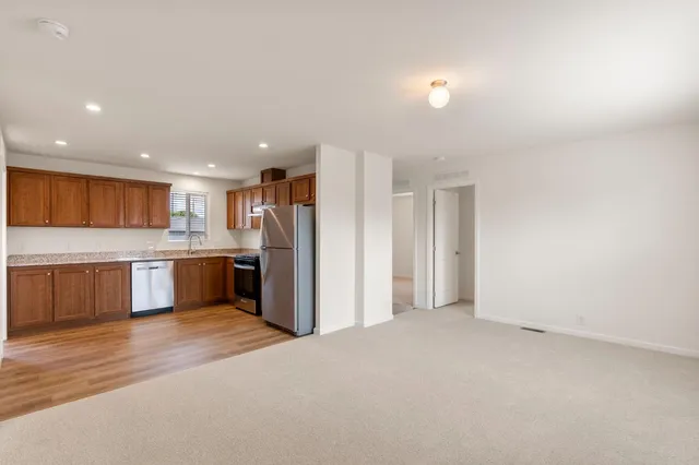 a large kitchen with a refrigerator and a sink