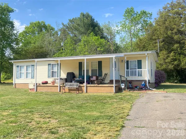 a front view of house with yard and outdoor seating